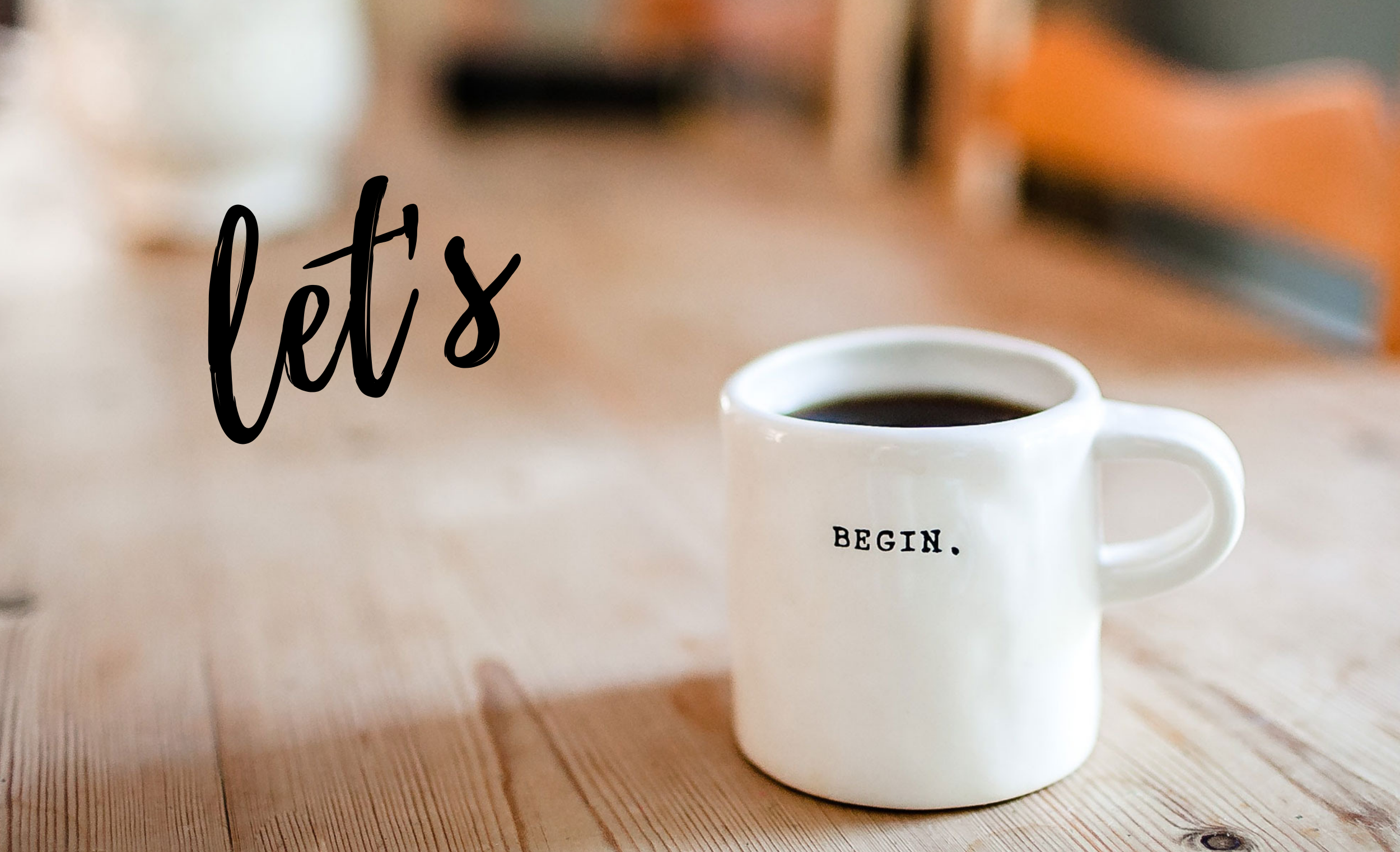 A coffee mug on the table with the word 'begin' written on the side